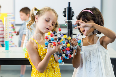 Girls looking at DNA model