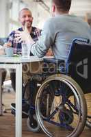 Happy handicap businessman discussing with colleague