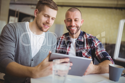 Front view of businessmen using digital tablets in office