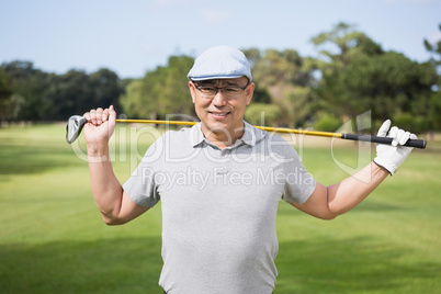 Portrait of confident man holding golf club