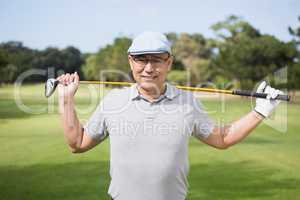 Portrait of confident man holding golf club