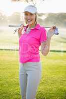 Portrait of smart woman carrying golf club