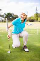 Smiling golfer woman clenching fist