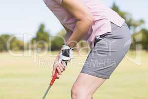 Midsection of woman playing golf