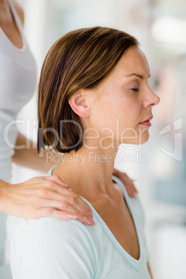 Cropped image of masseur giving massage to woman