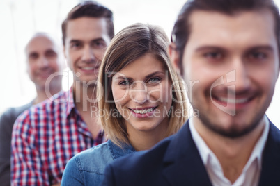 Businesswoman with coworkers standing in row