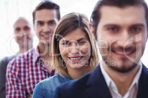 Businesswoman with coworkers standing in row