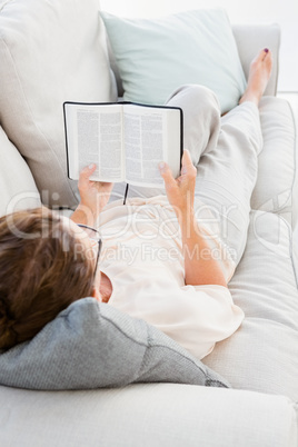 Full length of mature woman reading book