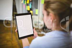 Businesswoman using digital tablet in meeting room