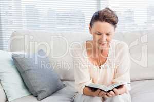 Smiling woman reading book
