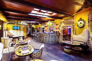 Tables and chairs in illuminated bar