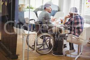 Full length of handicap businessman discussing with colleague