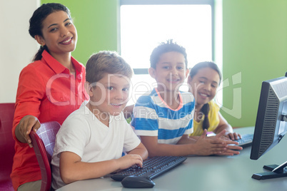 Portrait of smiling female teacher with children