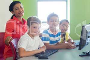Portrait of smiling female teacher with children