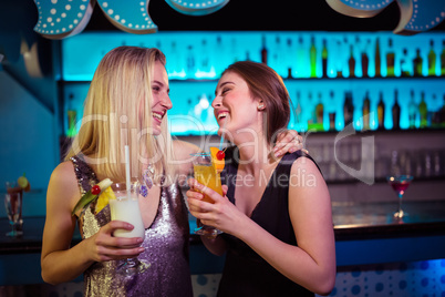 Pretty female friends enjoying at nightclub