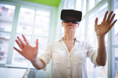 Female graphic designer using virtual reality headset