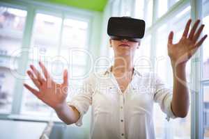Female graphic designer using virtual reality headset