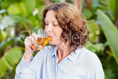 Mature woman drinking herbal tea