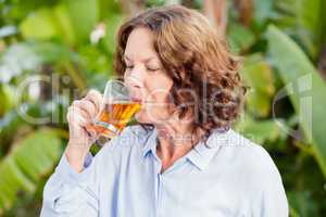 Mature woman drinking herbal tea