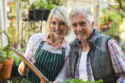 Confident gardeners outside greenhouse