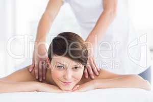 Portrait of smiling woman receiving massage