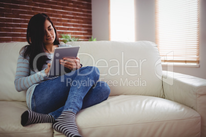 Young woman using digital tablet at home Young woman using digital tablet at home