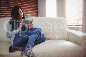 Young woman using digital tablet at home