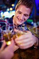 Cropped image of friend toasting with happy man