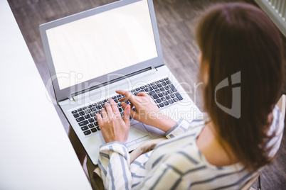 High angle view of executive typing on laptop at office