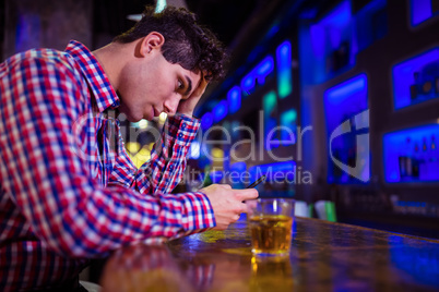 Frustrated man at bar counter