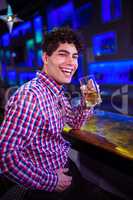 Portrait of man with beer laughing at bar counter