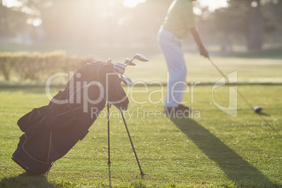 Golf bag with man in background