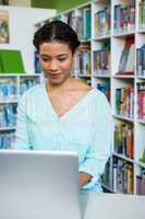 Woman working using laptop in library