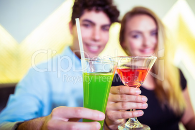 Smiling couple holding cocktail glasses