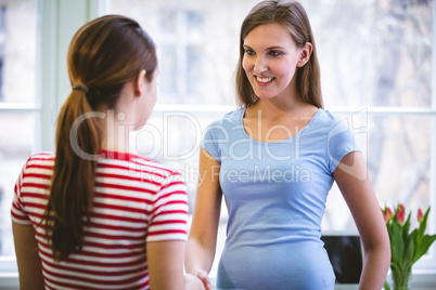 Happy professionals shaking hands at creative office