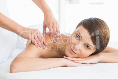 Portrait of beautiful woman receiving back massage