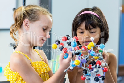 Girls holding DNA model