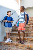 Schoolboys standing on staircase at school