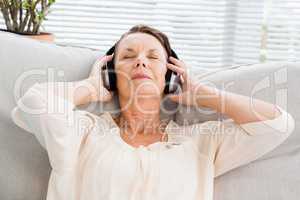 Close-up of mature woman listening to music