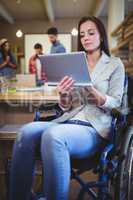 Disabled businesswoman using digital tablet