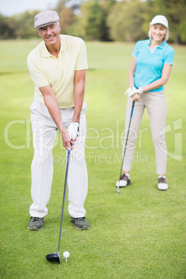 Portrait of man laying golf