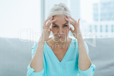 Portrait of senior woman suffering headache