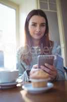 Portrait of beautiful woman with coffee at cafeteria