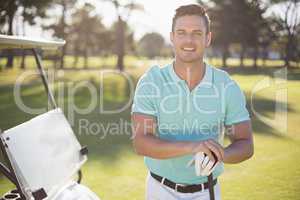 Portrait of happy young man with golf club