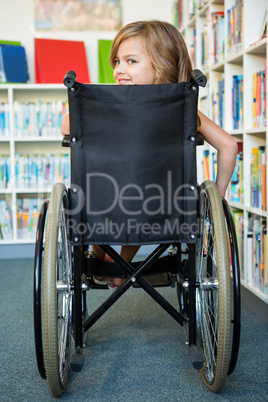 Rear view of handicapped girl at school library