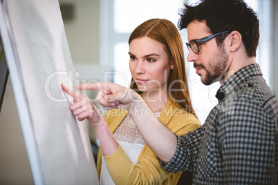 Business people pointing on whiteboard