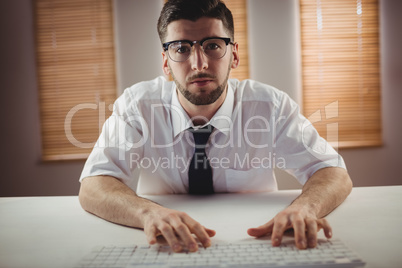 Portrait of man wearing eyeglass in office