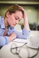 Businesswoman looking at document on table