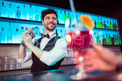Barkeeper preparing cocktail for customer