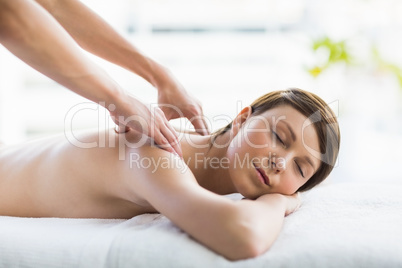 Relaxed beautiful woman enjoying back massage